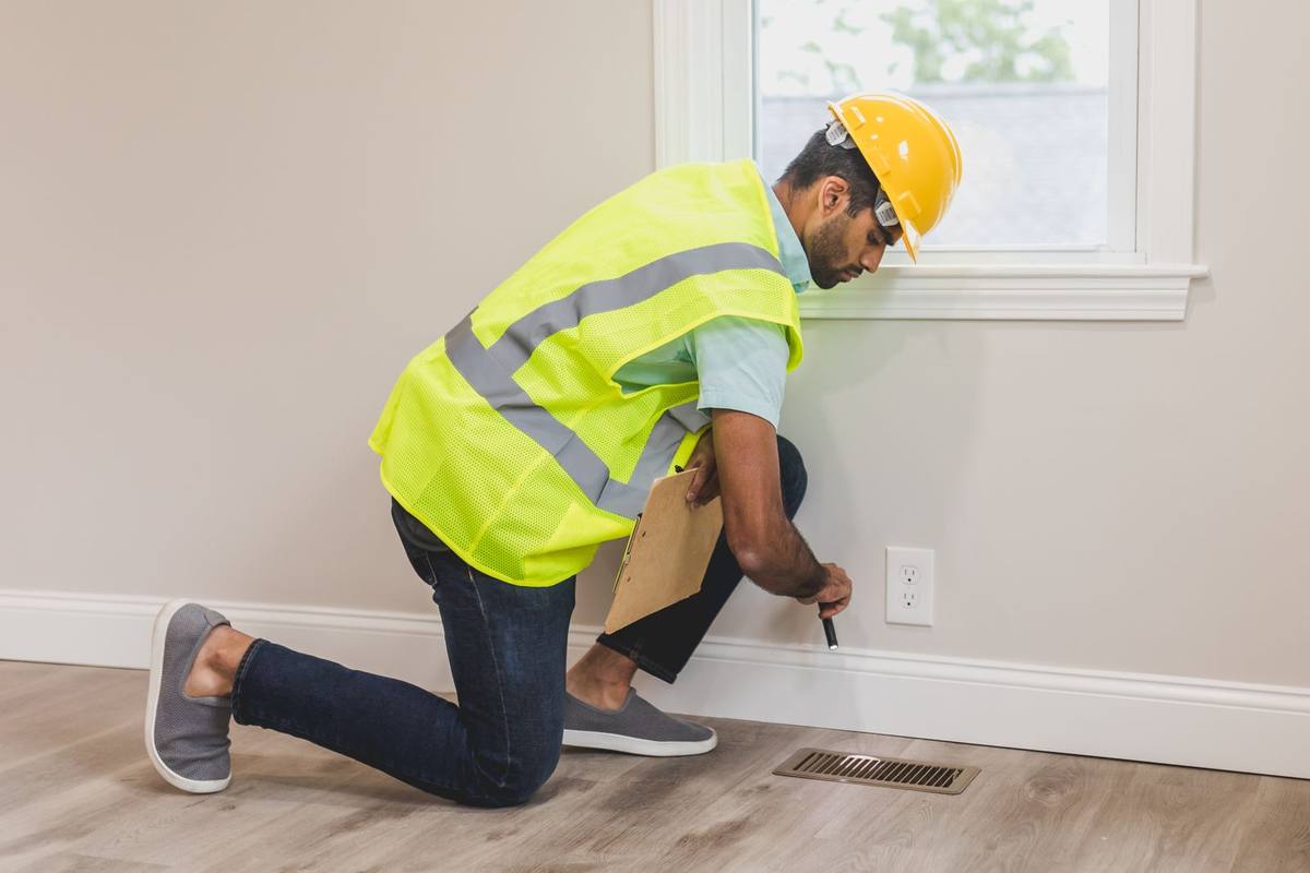 Inspector checking a floor vent