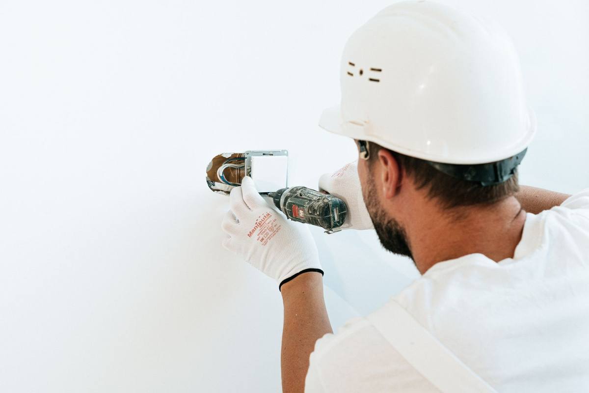 Electrician fixing a wall switch